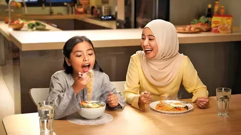 two women eating Maggi noodles
