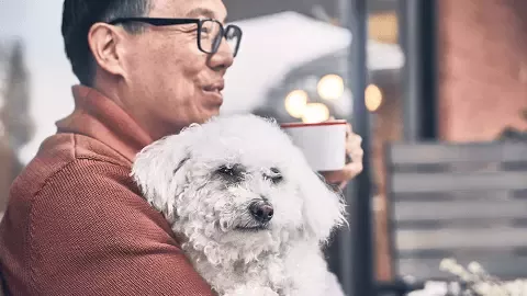man holding dog